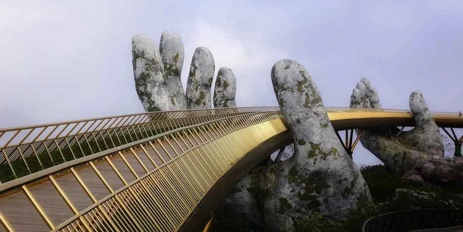 9-night-10-day-hanoi-siem-reap-vietnam-package-JustWravel-1752313170-The-walkabout-on-the-Golden-Hand-Bridge.webp