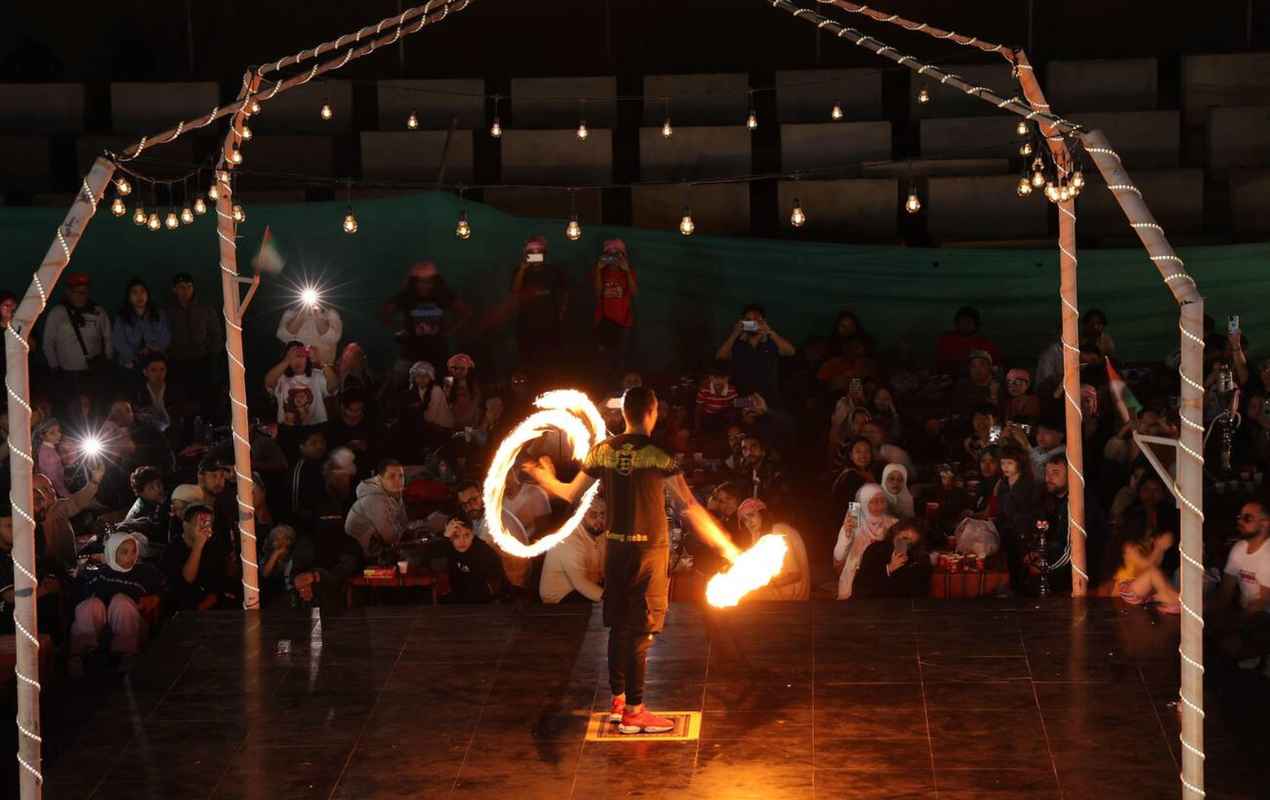 Dubai, UAE. A man performing fire dance in Desert camp in Dubai.