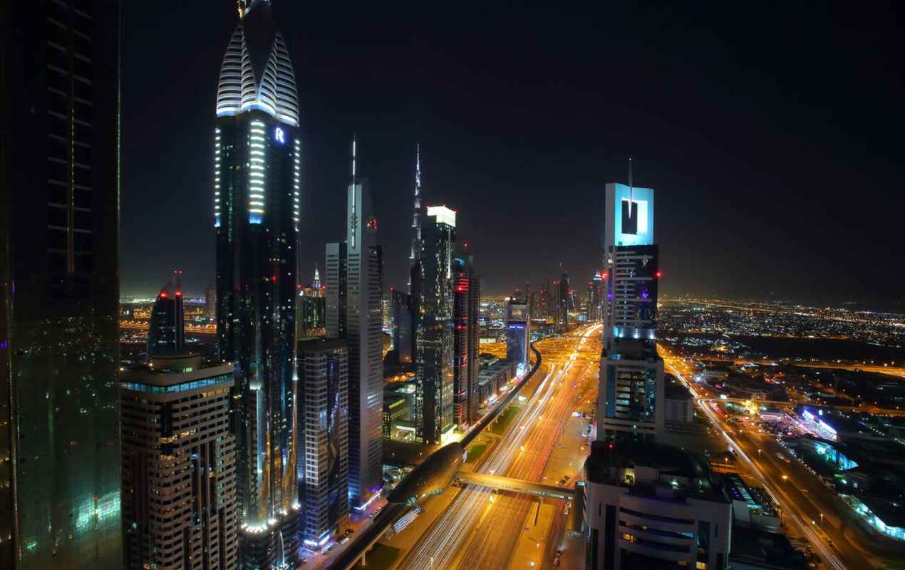 Skyscrapers along Sheikh Zayed Road at night, Dubai, United Arab Emirates.