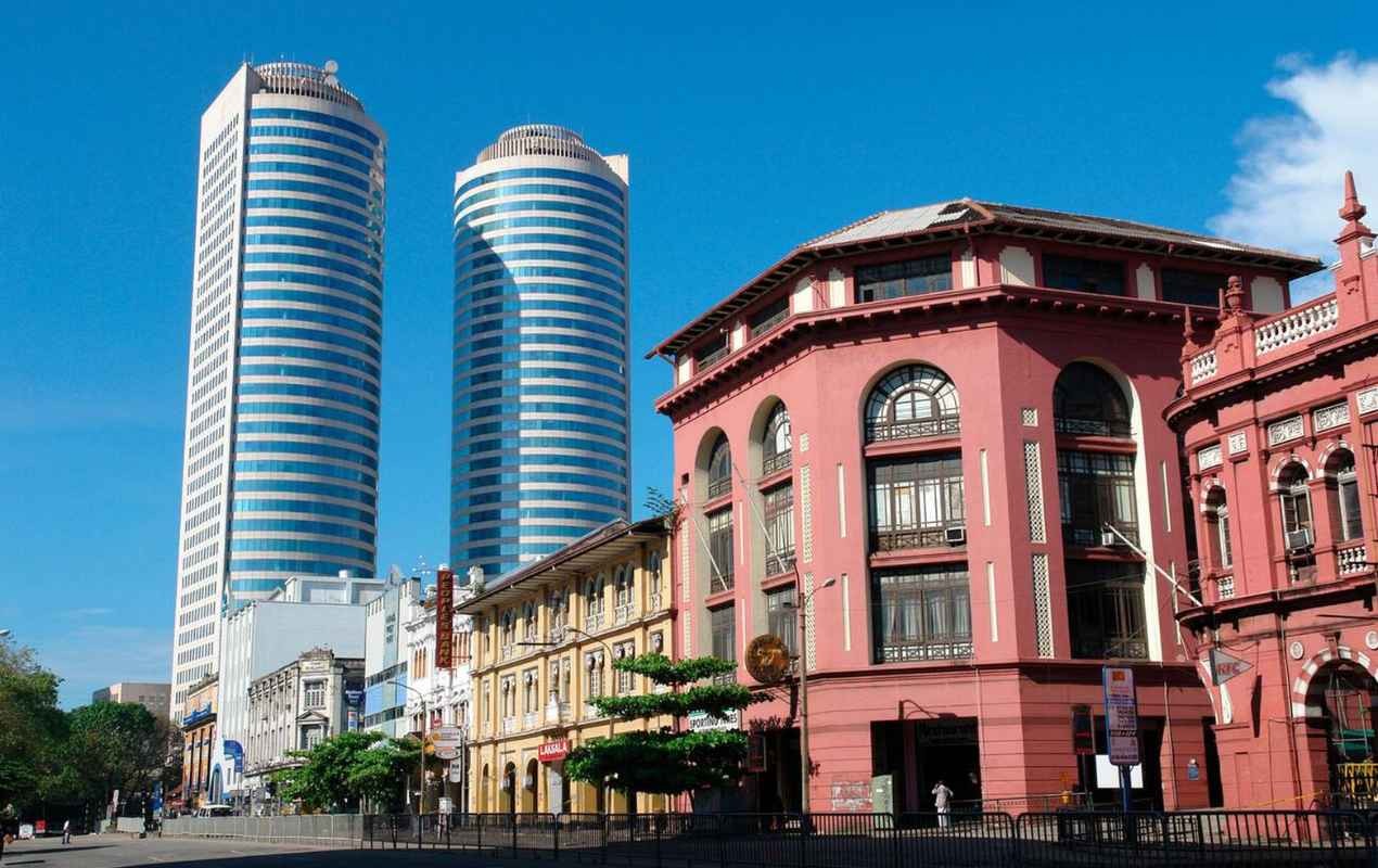 Colonial style trading houses and the twin towers of the World Trade Centre in the Fort area of Colombo, Sri Lanka.