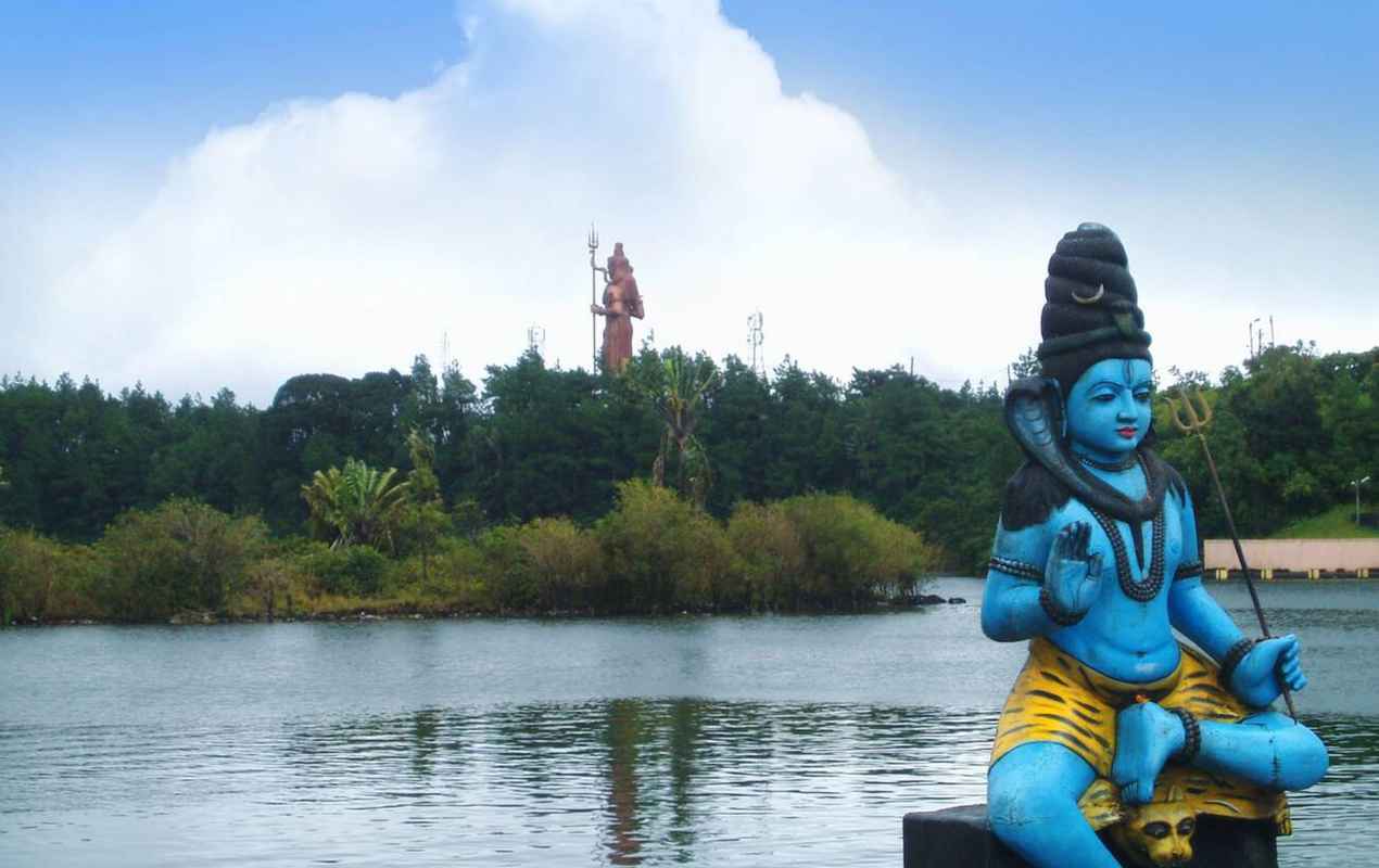 Sculpture of a Hindu God (Shiva) in front of crater lake Grand Bassin in Mauritius