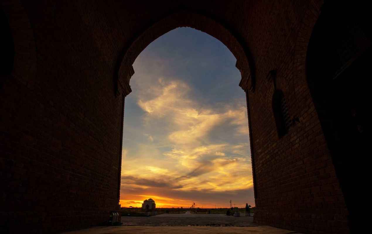 Arystan Bab Mausoleum silhouette sunset from the inside view