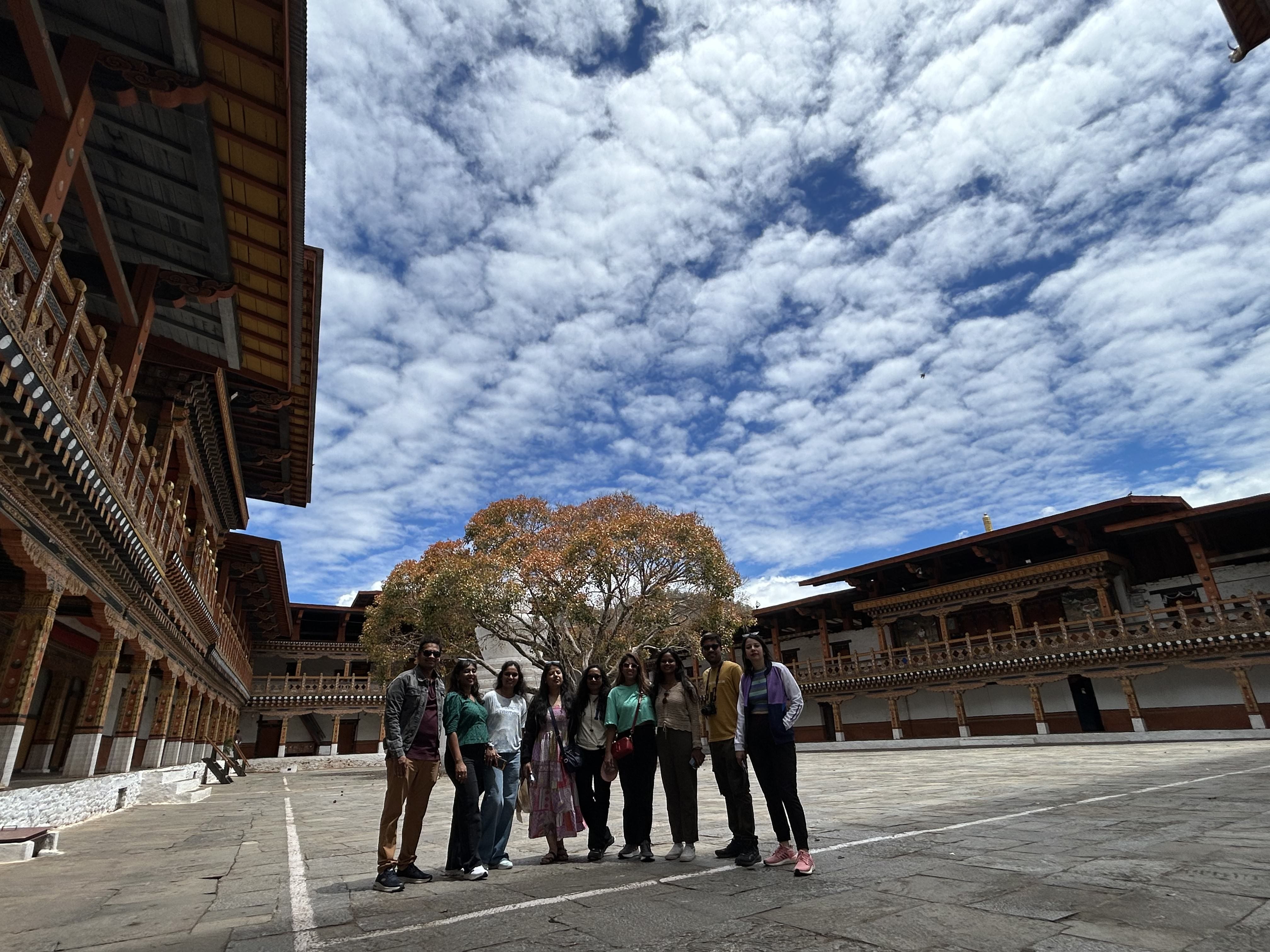 Wravelers posing with a beautiful sky in the backdrop