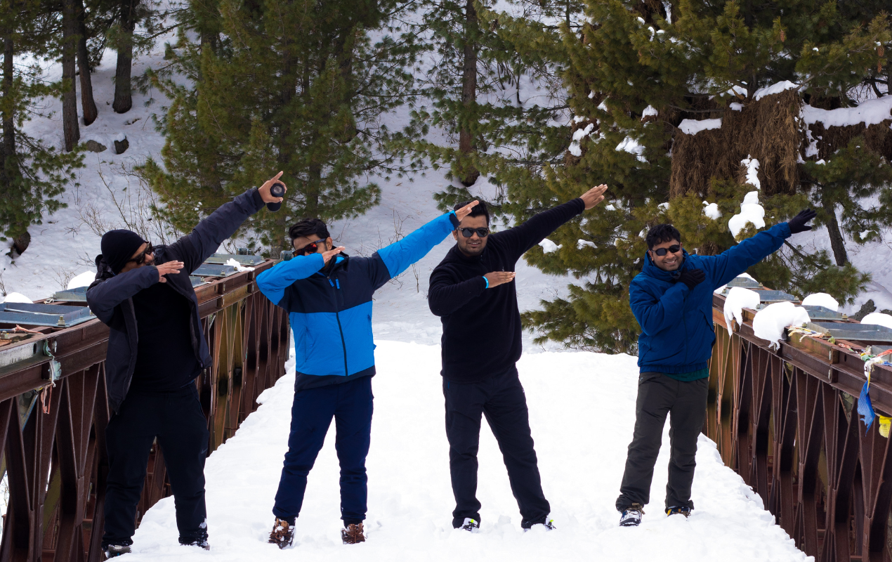 A fun dab with friends on a snow covered bridge